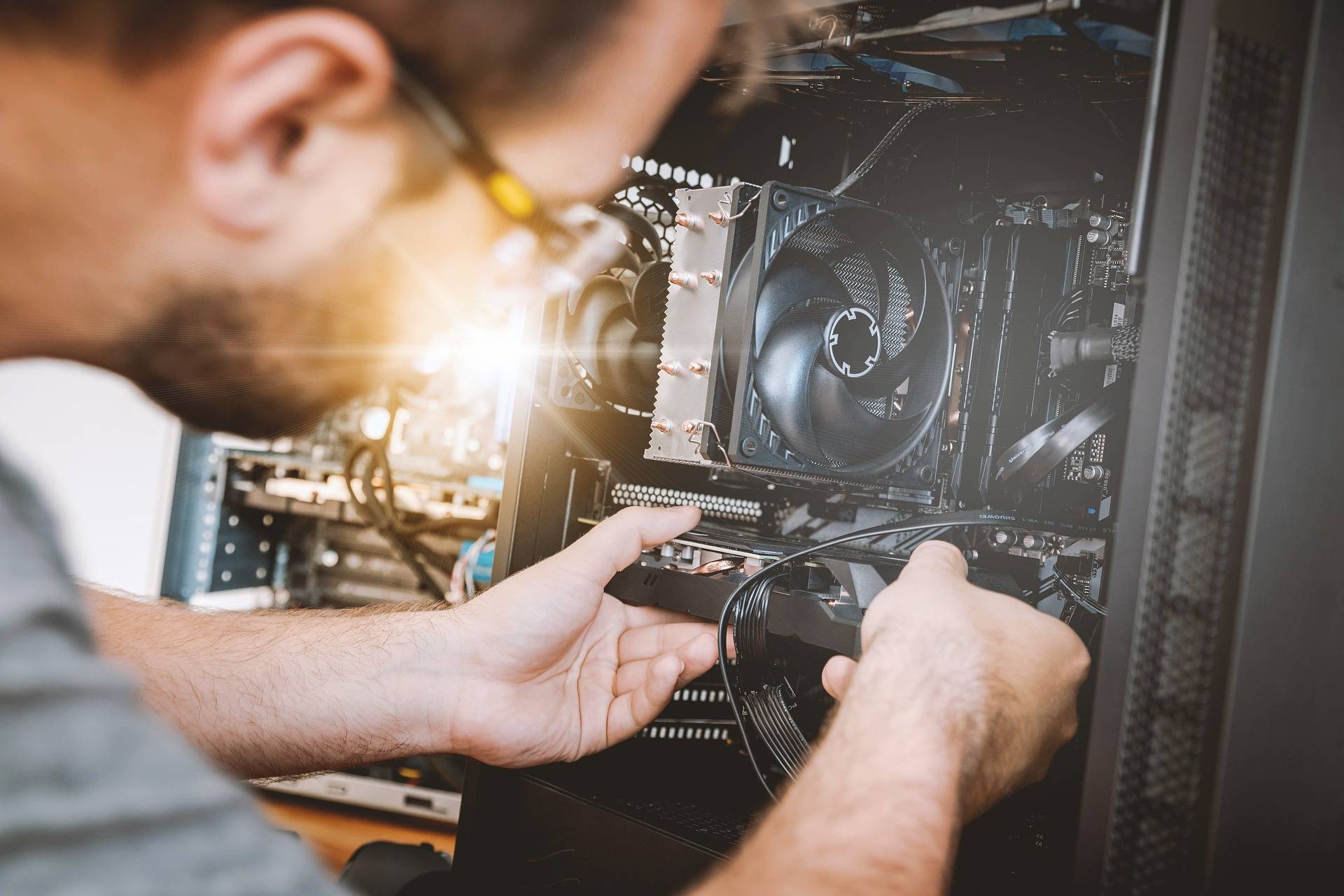 PIcture of an IT technician fixing a computer