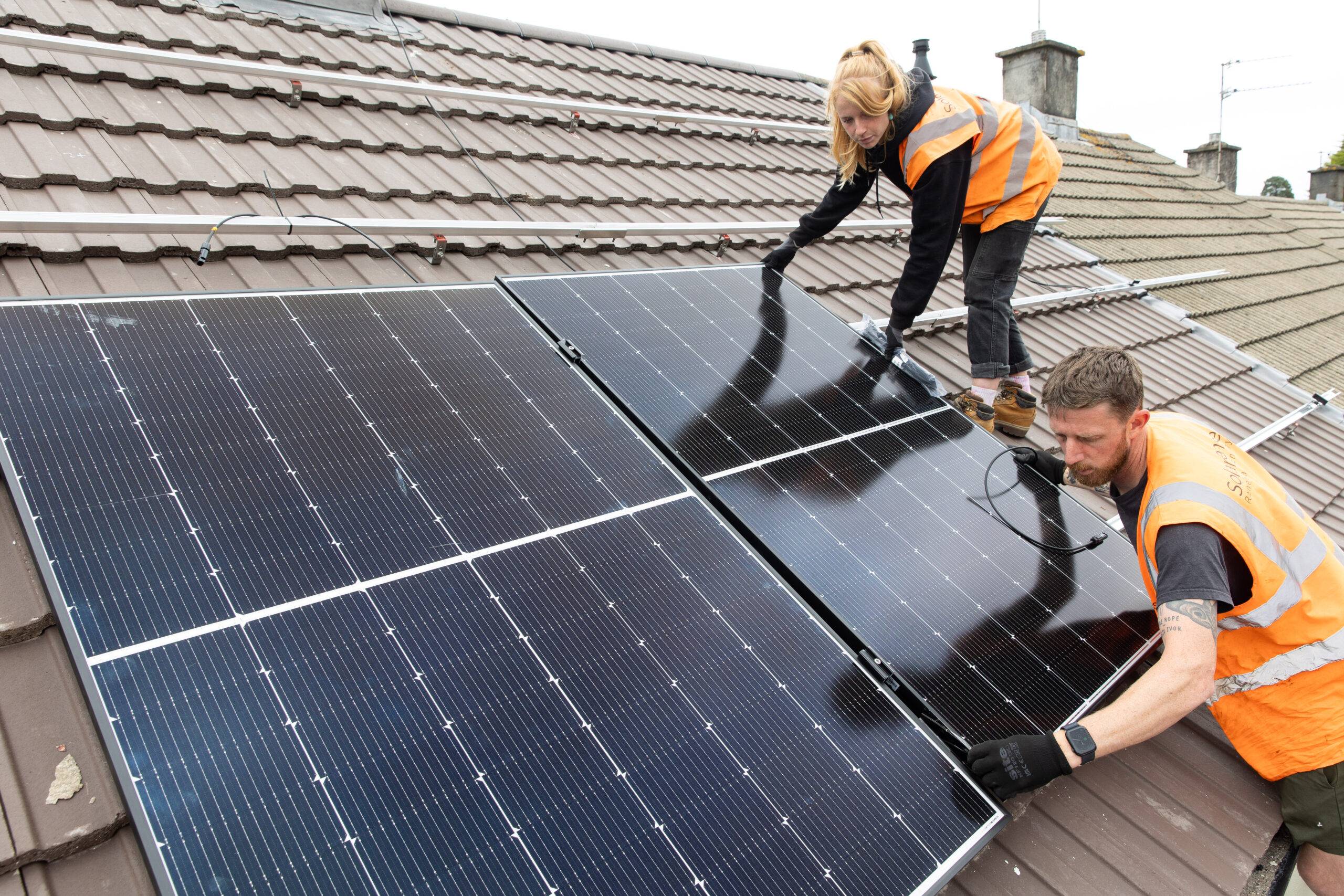 Person lifting a solar panel